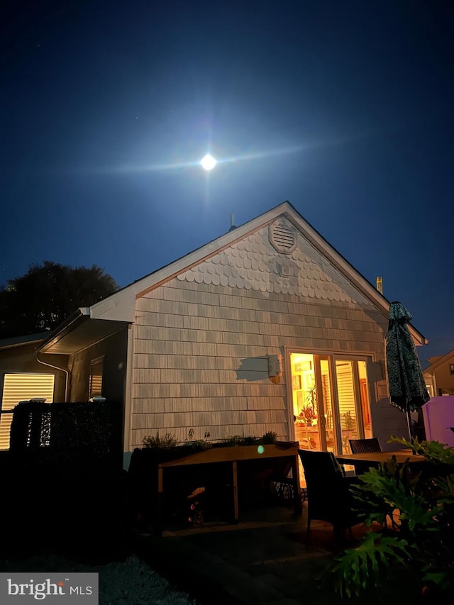 view of back house at twilight