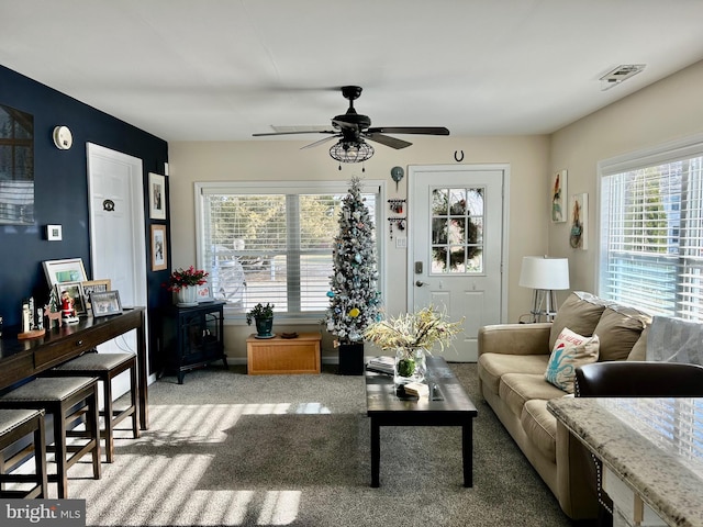 living room featuring light carpet and ceiling fan