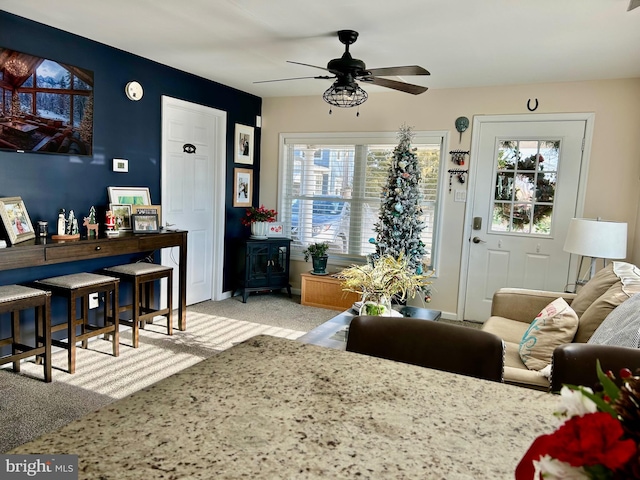 carpeted living room with plenty of natural light and ceiling fan