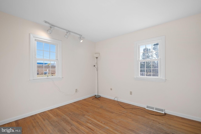 spare room with hardwood / wood-style floors