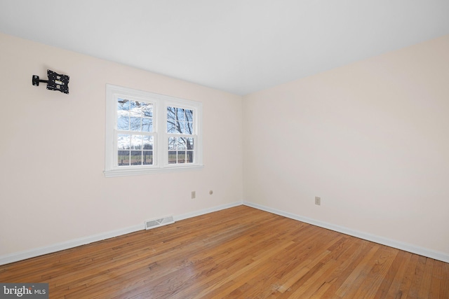 spare room featuring hardwood / wood-style flooring