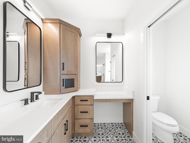 bathroom with tile patterned flooring, vanity, and toilet