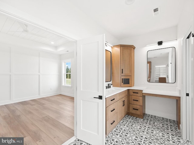 bathroom with hardwood / wood-style flooring and vanity