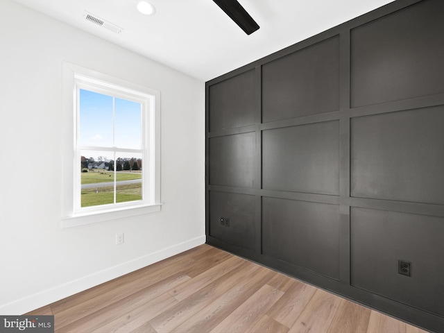 unfurnished bedroom with ceiling fan and light wood-type flooring