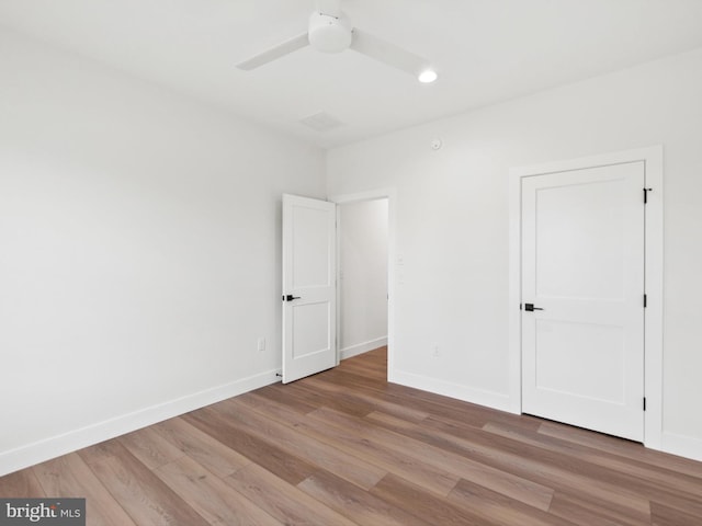 empty room featuring ceiling fan and light wood-type flooring