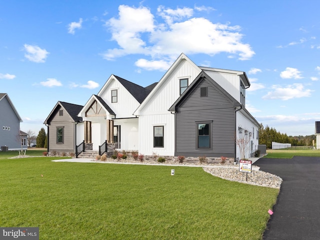 modern farmhouse featuring a front lawn