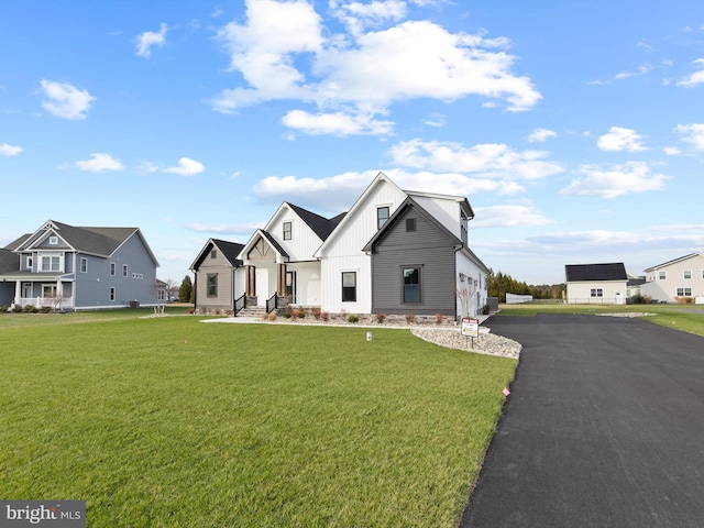 modern inspired farmhouse featuring a front lawn