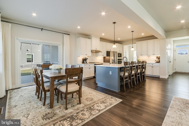 dining space featuring dark hardwood / wood-style flooring