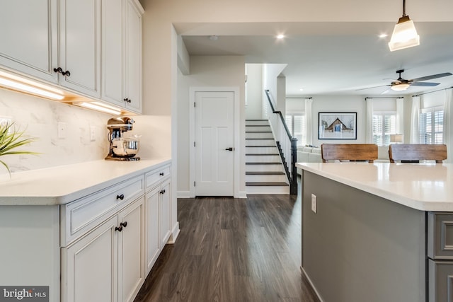 kitchen featuring a wealth of natural light, dark hardwood / wood-style flooring, ceiling fan, and pendant lighting