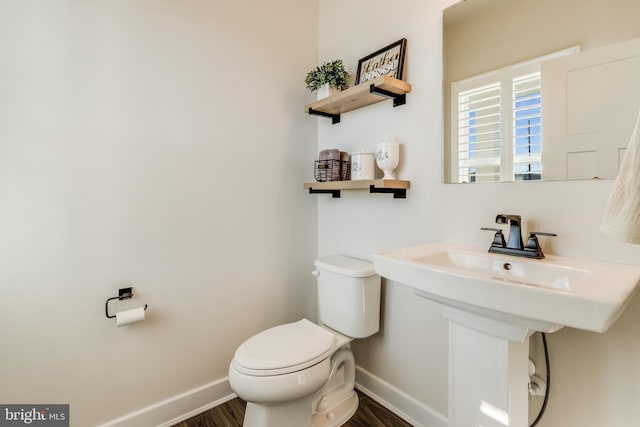 bathroom featuring hardwood / wood-style flooring and toilet