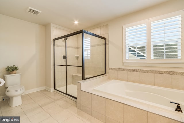 bathroom featuring tile patterned flooring, toilet, and plus walk in shower