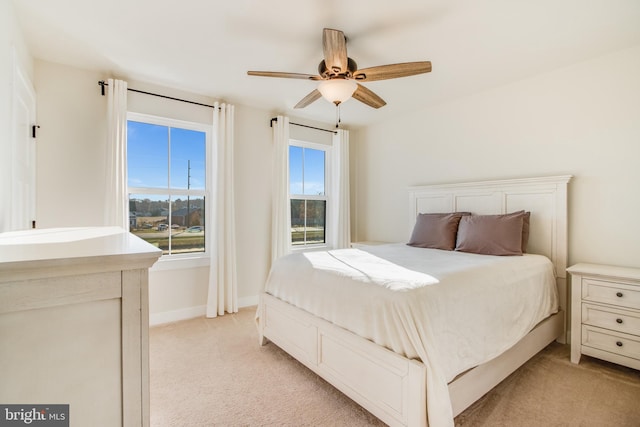 bedroom featuring light colored carpet and ceiling fan