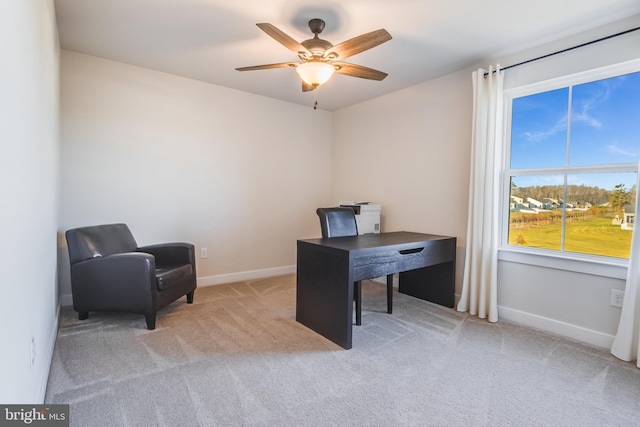 carpeted office featuring ceiling fan