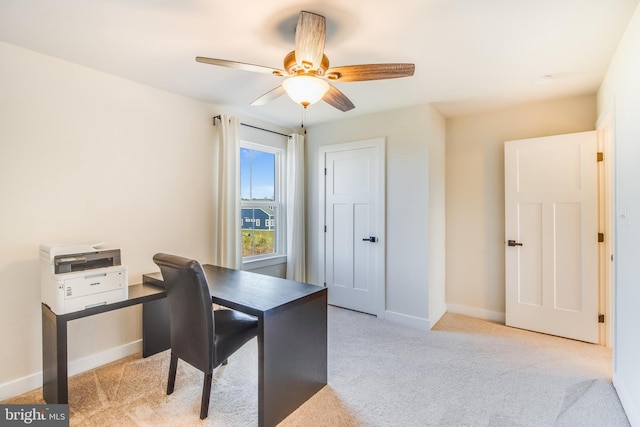 office space featuring light carpet and ceiling fan