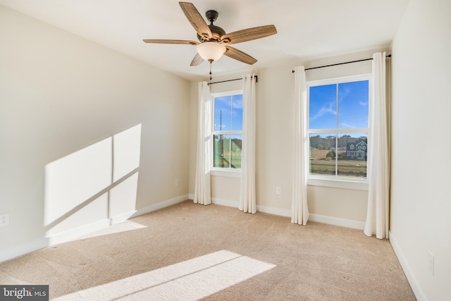 unfurnished room with light carpet and ceiling fan