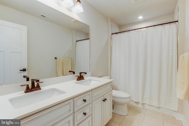 full bathroom featuring toilet, shower / tub combo, vanity, and tile patterned floors