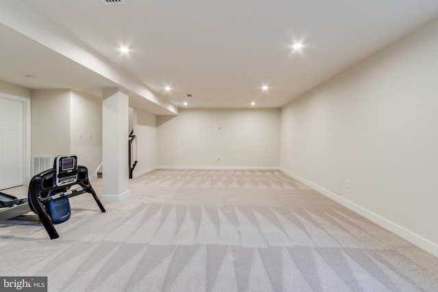 exercise room featuring light carpet