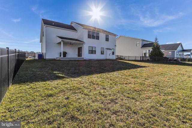 rear view of property with a lawn