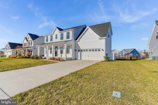 view of front of home featuring a porch, a garage, and a front lawn