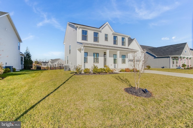 view of front of home with covered porch and a front lawn