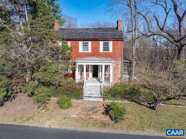 colonial inspired home featuring a porch