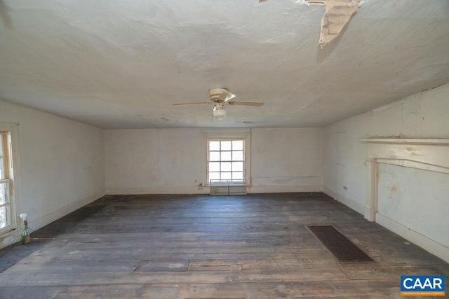 spare room with dark hardwood / wood-style flooring, ceiling fan, and lofted ceiling