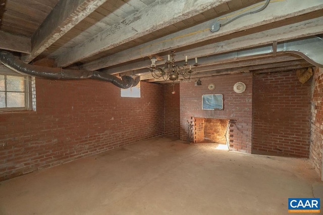 basement featuring a chandelier and a healthy amount of sunlight