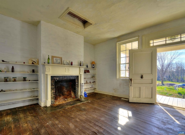 unfurnished living room featuring dark hardwood / wood-style floors and a fireplace