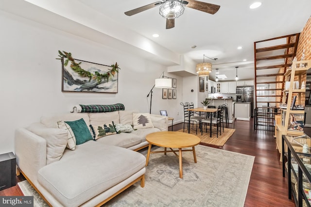 living room with ceiling fan and dark hardwood / wood-style floors