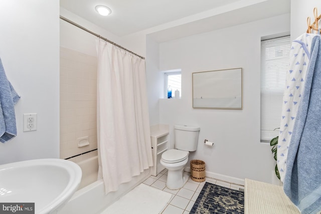 bathroom with toilet, tile patterned floors, and shower / bath combo with shower curtain