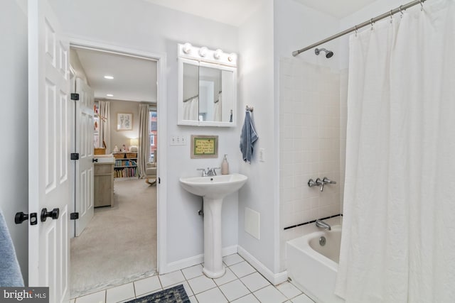 bathroom with tile patterned flooring, shower / bath combination with curtain, and sink