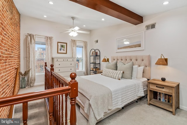 carpeted bedroom featuring ceiling fan and beamed ceiling