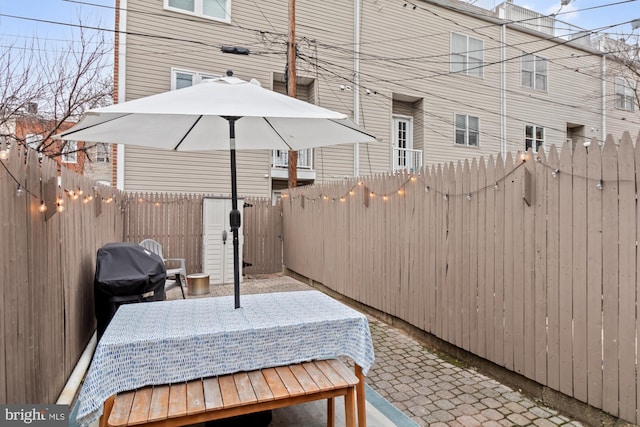 view of patio featuring a grill