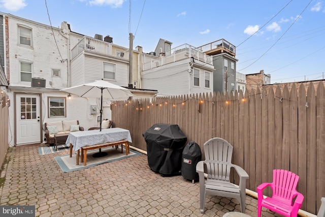 view of patio with a grill, outdoor lounge area, and cooling unit