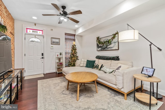 living room with ceiling fan and dark hardwood / wood-style floors