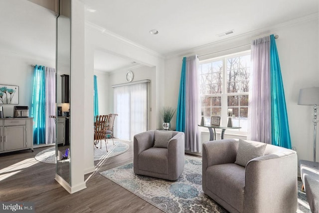 living area featuring ornamental molding and dark hardwood / wood-style flooring