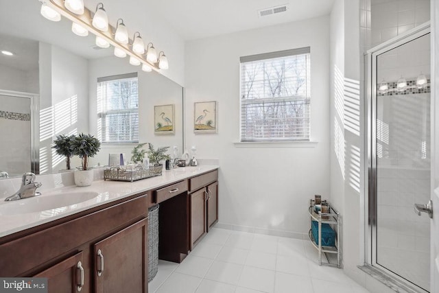 bathroom with vanity, a shower with shower door, and tile patterned flooring