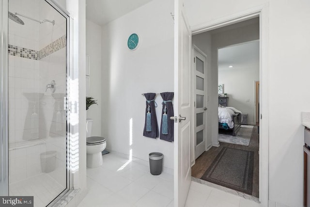 bathroom featuring toilet, vanity, tile patterned floors, and walk in shower