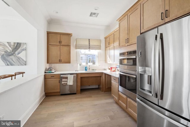 kitchen with crown molding, appliances with stainless steel finishes, backsplash, and light wood-type flooring