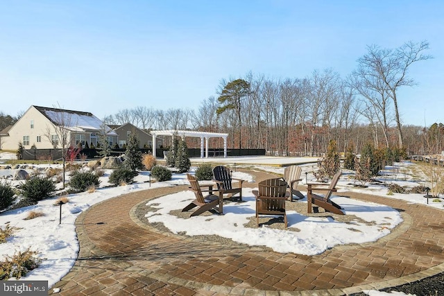 snow covered patio featuring a pergola