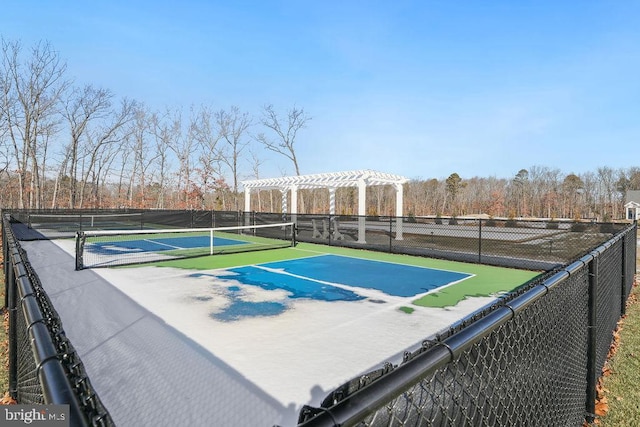 view of tennis court with a pergola