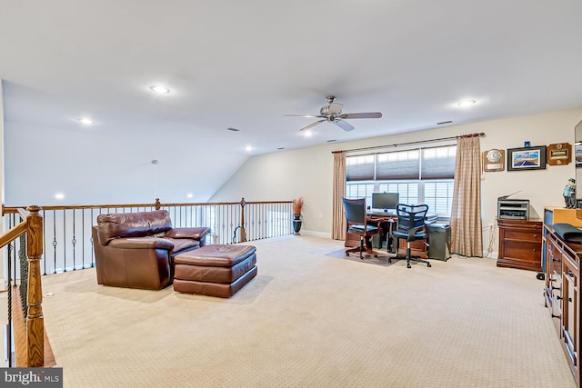 carpeted living room with ceiling fan and vaulted ceiling