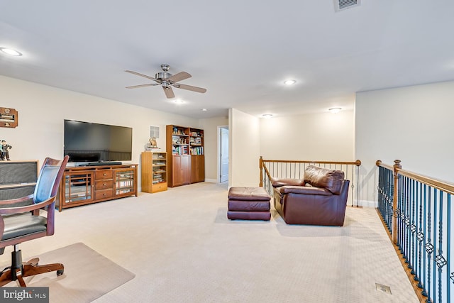 carpeted living room featuring ceiling fan