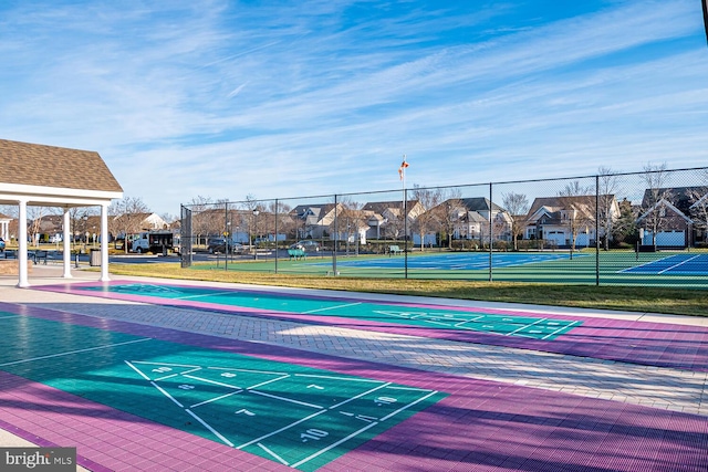 surrounding community featuring tennis court