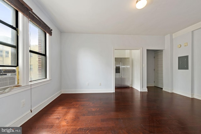 spare room with dark hardwood / wood-style floors and electric panel