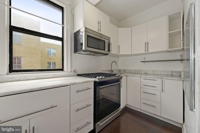 kitchen with range with electric cooktop, white cabinetry, dark wood-type flooring, and sink