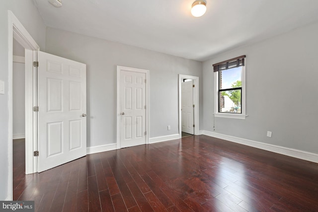 unfurnished bedroom featuring dark hardwood / wood-style floors