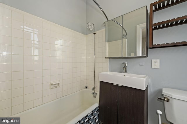 full bathroom with tiled shower / bath combo, toilet, and vanity