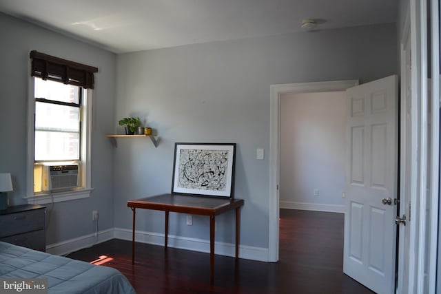 bedroom featuring cooling unit and dark wood-type flooring