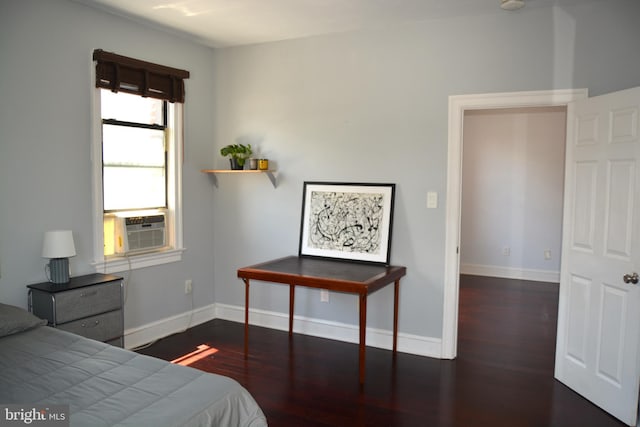 bedroom featuring cooling unit and dark wood-type flooring